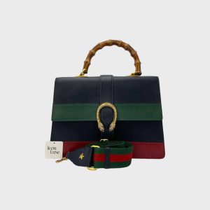 Stylish designer handbag featuring a braided handle, a bold striped pattern in navy, green, and red, and a signature buckle closure, perfect for adding a touch of elegance to any outfit.